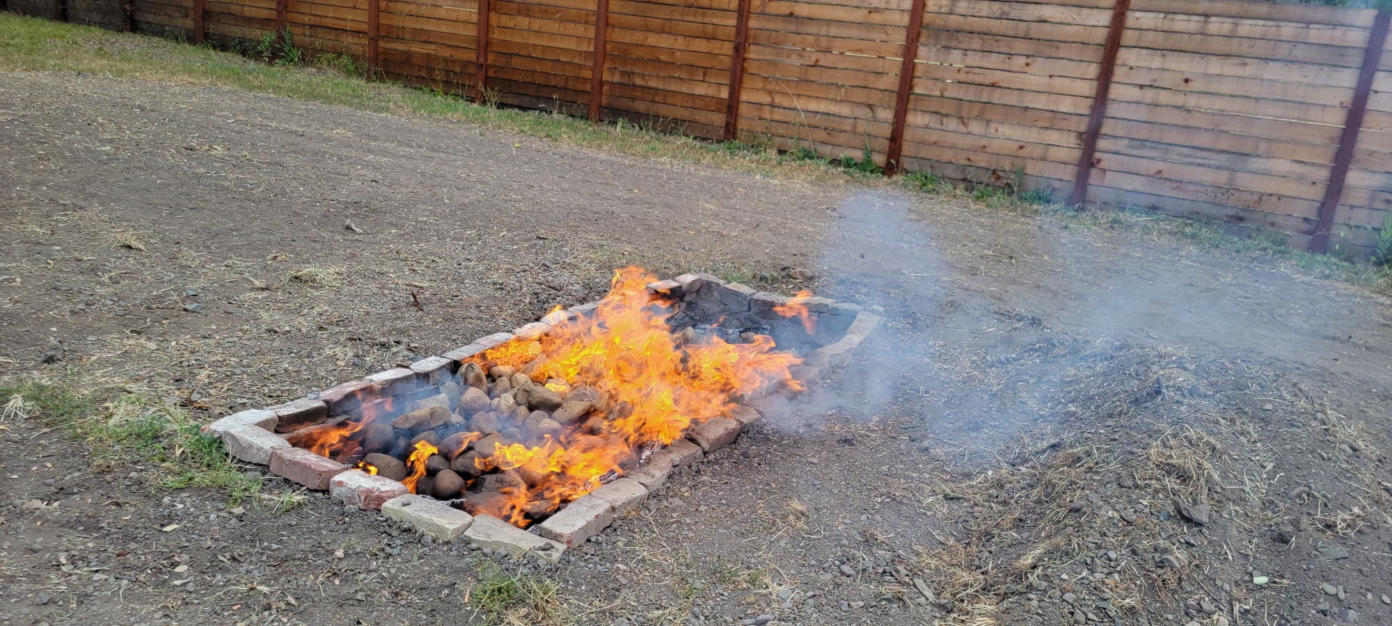 The fire, burning down with rocks on top